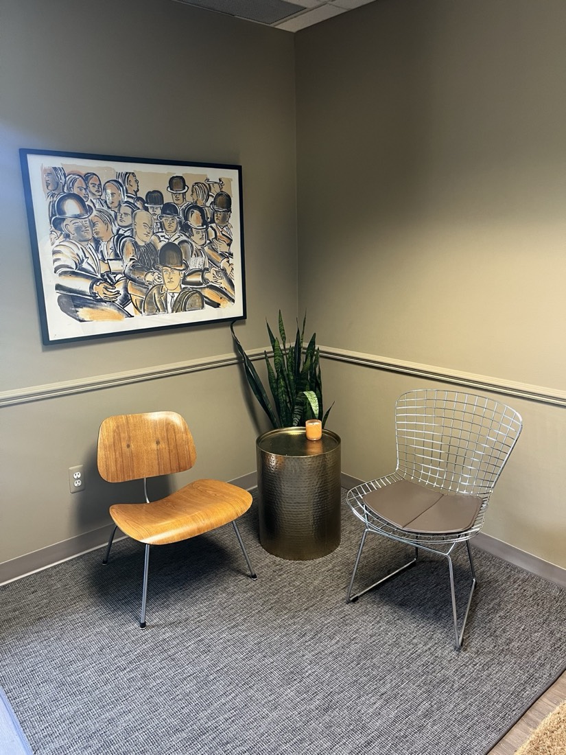 Seating corner with a molded lounge chair and framed artwork